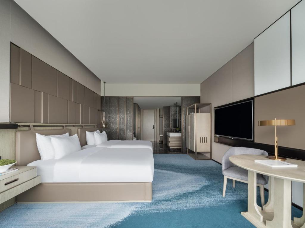 Postel nebo postele na pokoji v ubytování Tianyuan Grand Hotel Xiamen