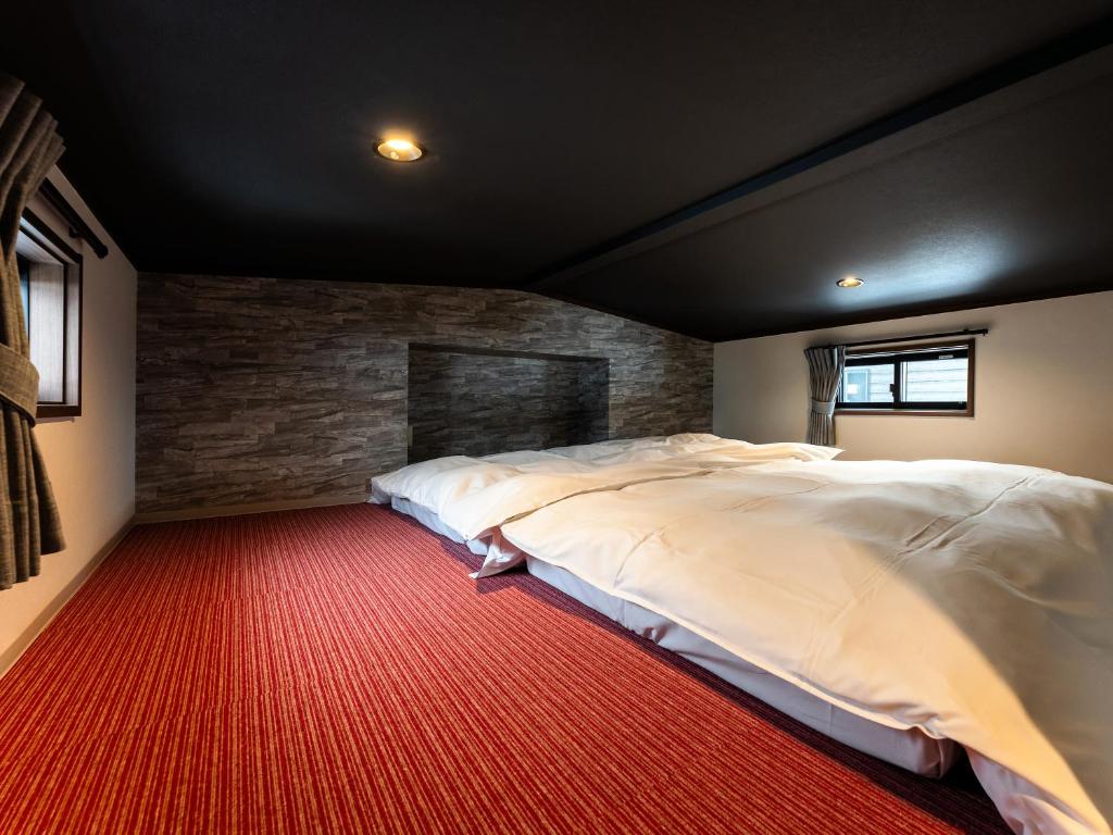 Postel nebo postele na pokoji v ubytování Myoko Onsen cottage Ajisai