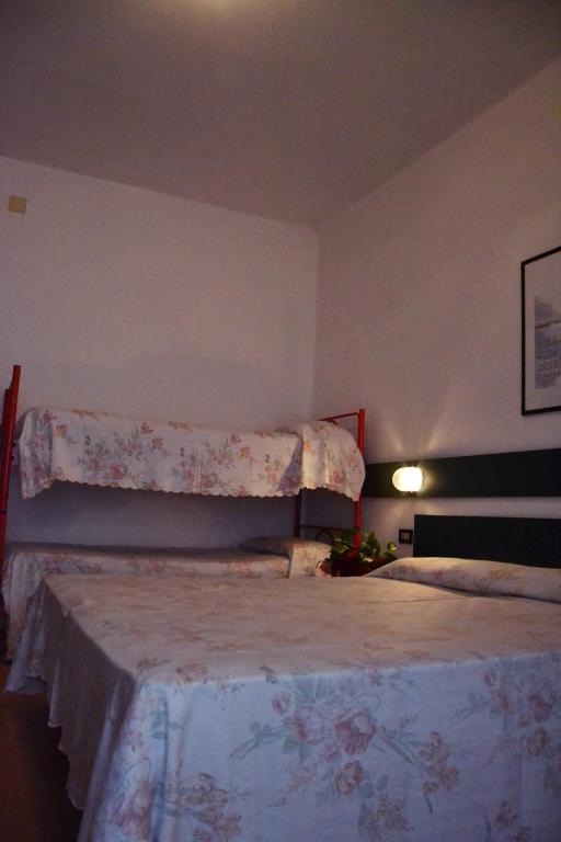 Postel nebo postele na pokoji v ubytování Hotel Rex