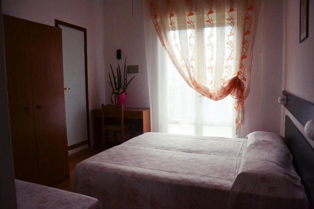 Postel nebo postele na pokoji v ubytování Hotel Rex
