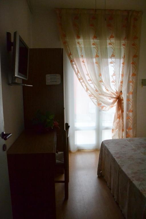 Postel nebo postele na pokoji v ubytování Hotel Rex