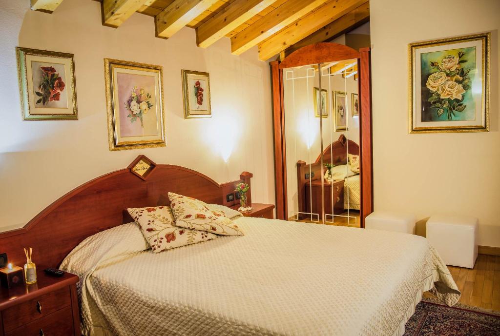 a bedroom with a bed with a white comforter at Hotel San Paolo in Camposampiero