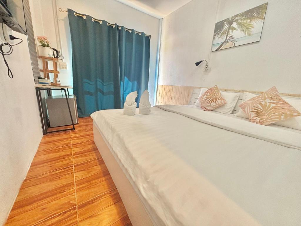 Postel nebo postele na pokoji v ubytování บ้านหมอบิวรีสอร์ทเชียงคาน BaanmhorbiwResortChiangKhan