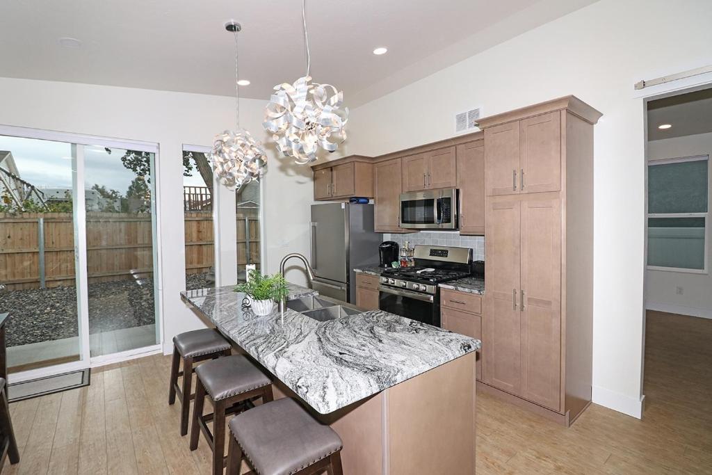 a kitchen with a large island with a counter top at Tranquil Modern Haven home in Grand Junction