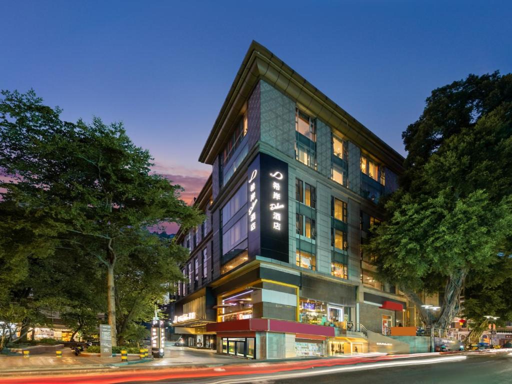 a building on the corner of a street at XANA Deluxe International Hotel Dongshankou Metro Station Branch - Free Shuttle Bus to Canton Fair Complex During Canton Fair Period in Guangzhou
