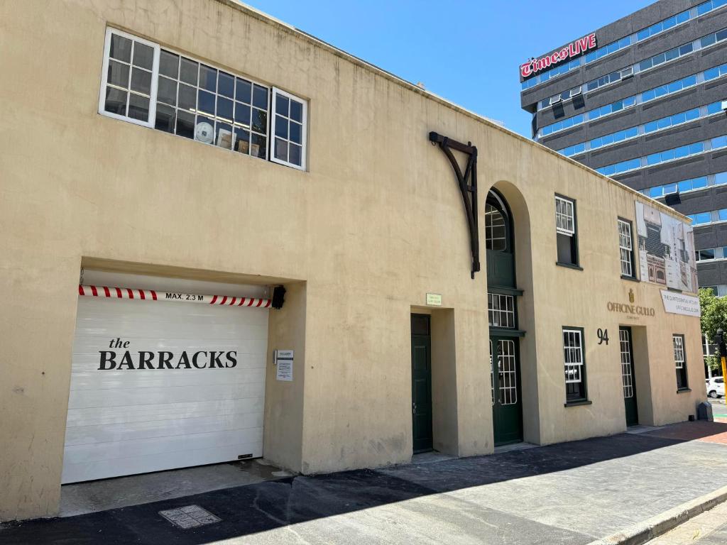 a building with two garage doors with the barnyards written on it at Bree Street Apartment - Explore, Eat, Experience Cape Town in Cape Town