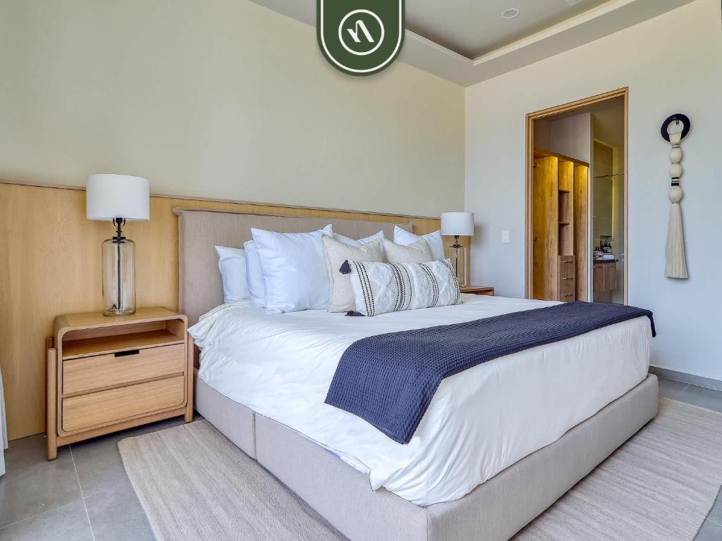 a bedroom with a large bed with white sheets and pillows at Luxury Oceanfront 3 BR Condo - Private Jacuzzi in Cruz de Huanacaxtle