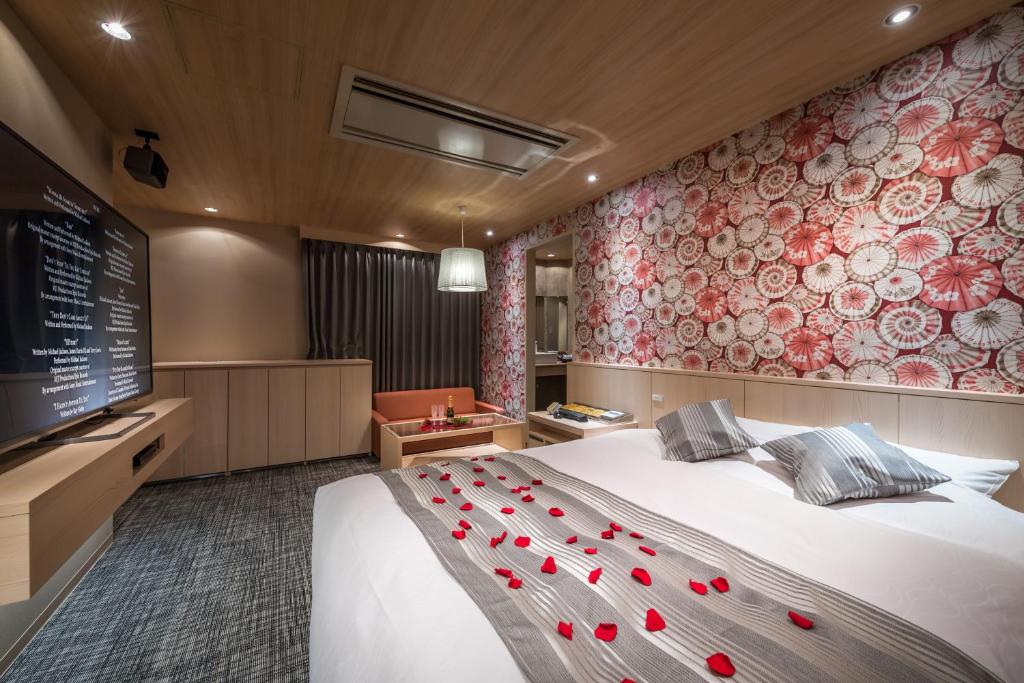 Postel nebo postele na pokoji v ubytování ホテルイエロー宇都宮 - 大人専用 -