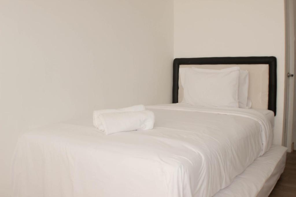 Ένα ή περισσότερα κρεβάτια σε δωμάτιο στο Comfy and Tidy Studio at Riverview Jababeka Apartment By Travelio