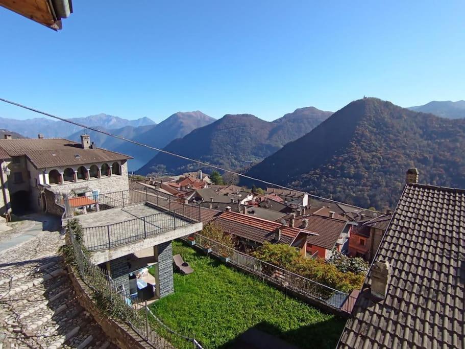 a view of a village with mountains in the background at Casa del Sole in Casasco Intelvi