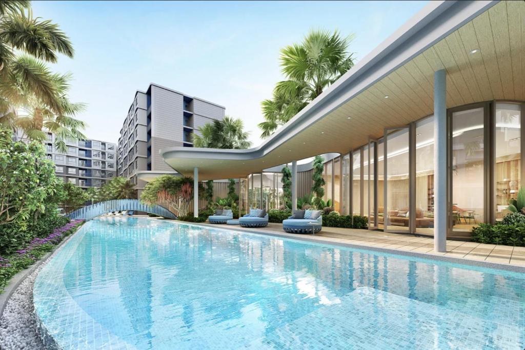 an external view of a building with a swimming pool at DCondo Reef Kathu, Phuket in Kathu