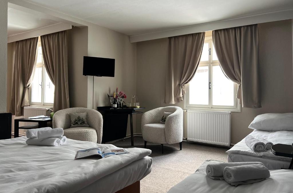Postel nebo postele na pokoji v ubytování Hotel Lomnice