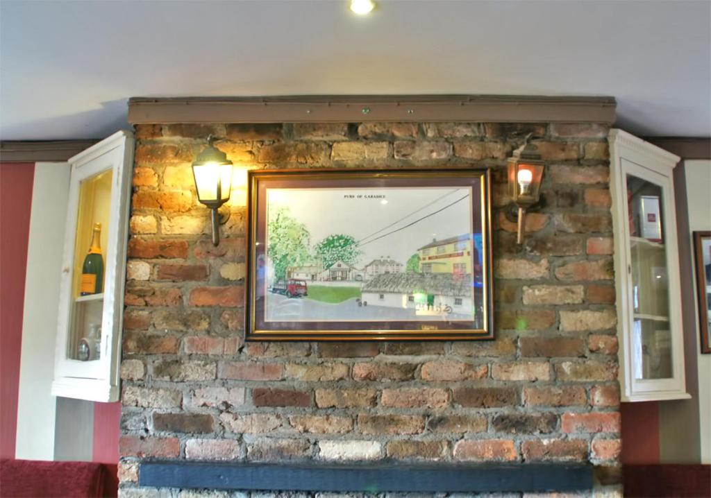 a picture on a brick wall with a picture on it at Hatton's of Garadice in Garadice