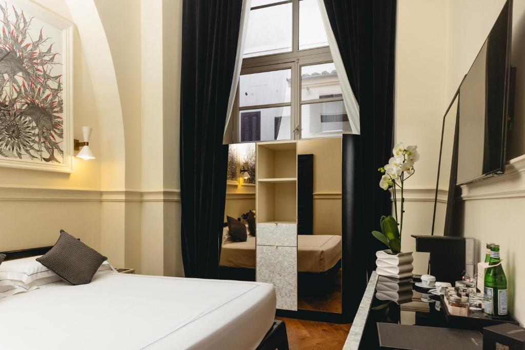 a hotel room with a bed and a window at Roma Luxus Hotel in Rome
