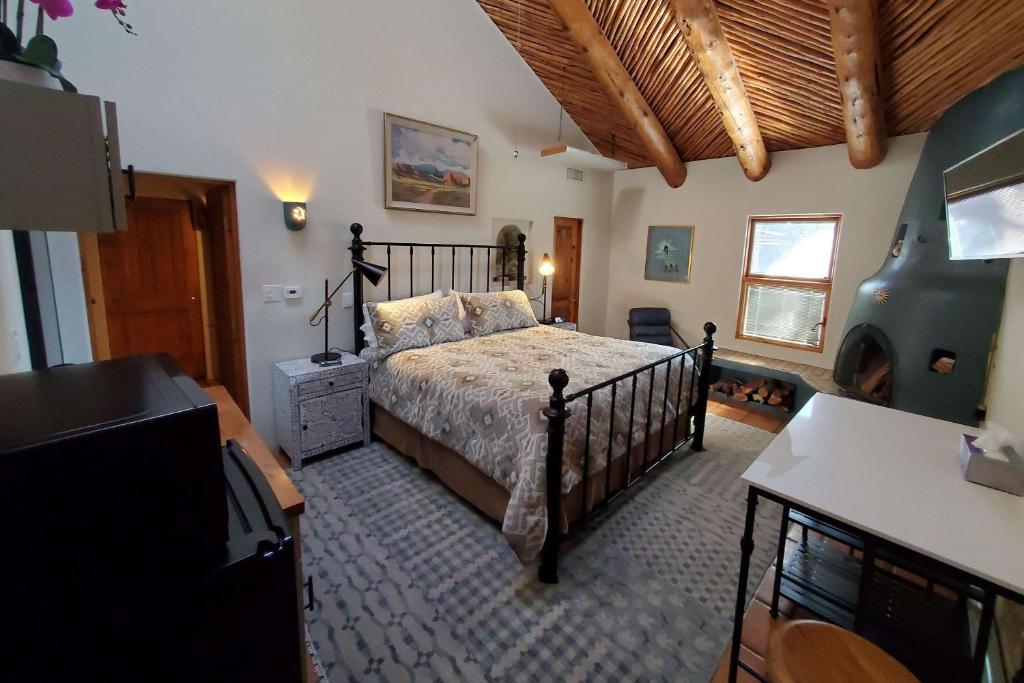 a bedroom with a bed and a tv in a room at Casas de Suenos Old Town Historic Inn, Ascend Hotel Collection in Albuquerque