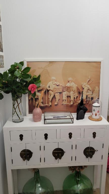 a white dresser with vases on top of it at House Pajarillo in Vigo