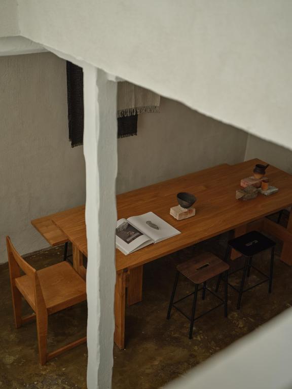 a room with a wooden table with two chairs at Noura Residency City Apartment II in Copenhagen