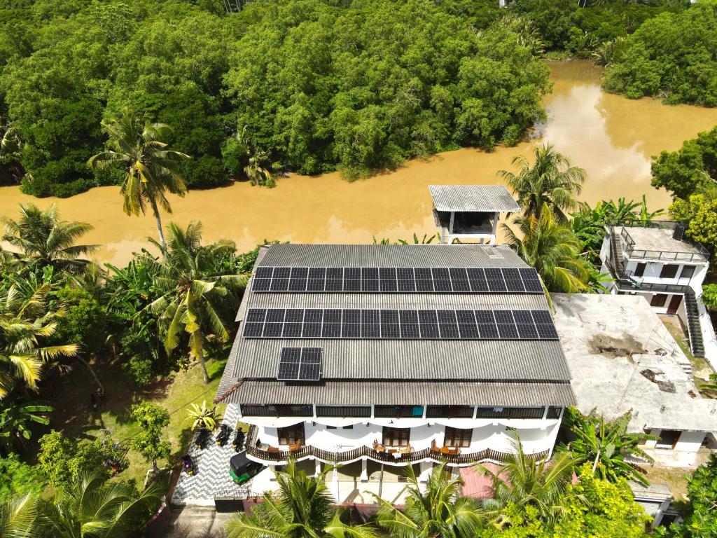 an aerial view of a house with solar panels on the roof at Riverwood villa in Weligama