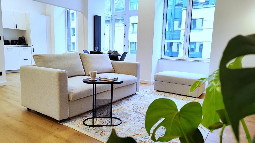 a living room with a couch and a table at Le Cocon Studio in Brussels