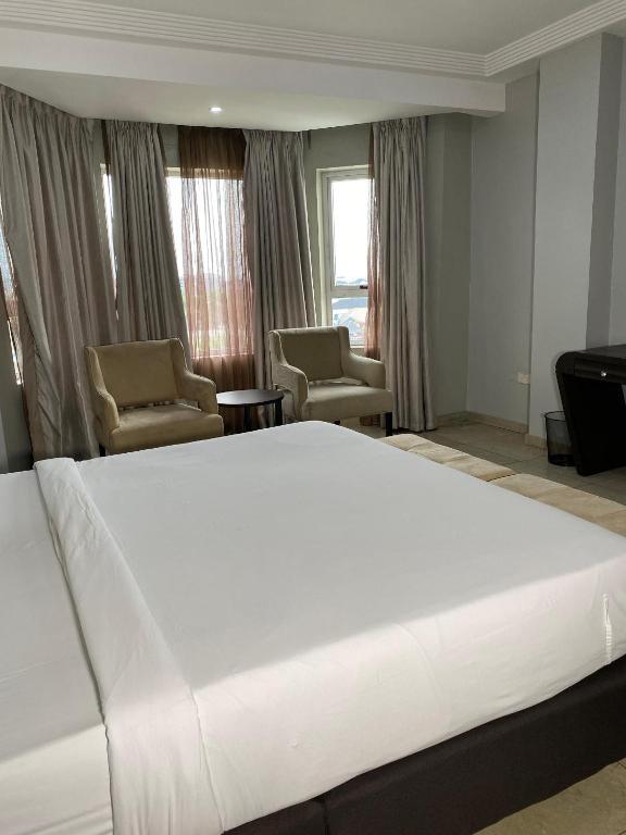 Voodi või voodid majutusasutuse Genesis Reventon Hotel toas
