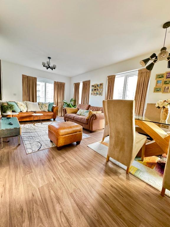 a large living room with a table and chairs at The Mirrored House in Kent