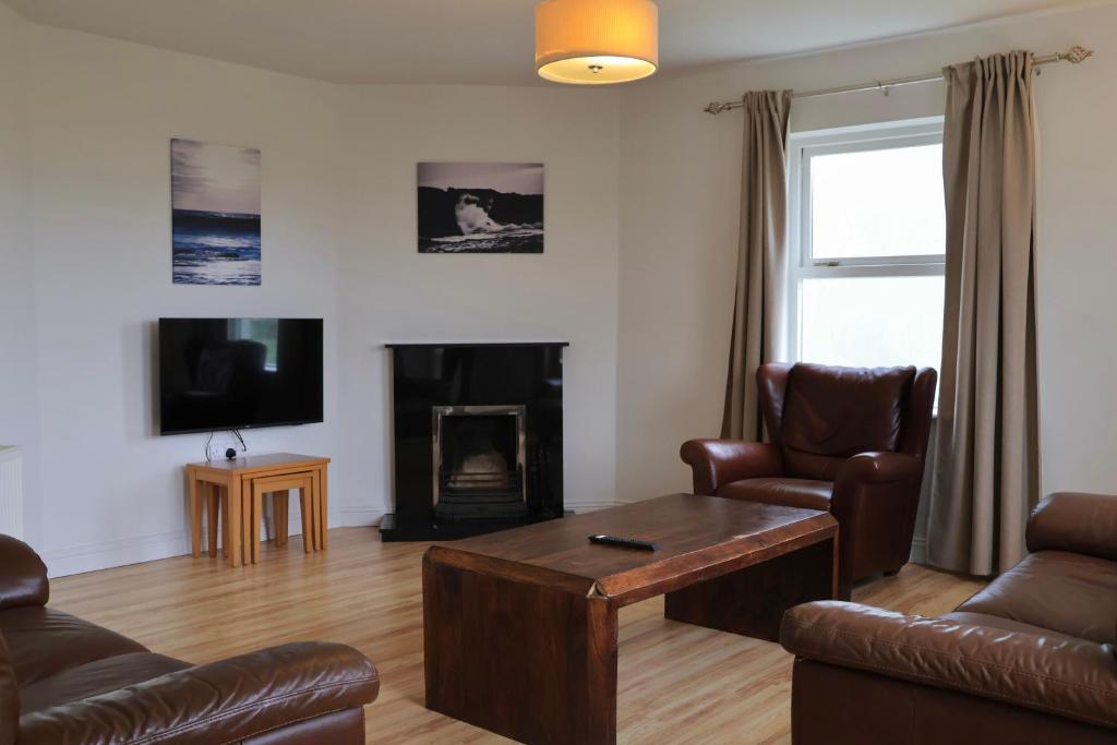 a living room with a couch and a coffee table at Doolin Village Lodges in Doolin