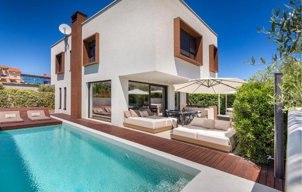 a villa with a swimming pool and a house at 3 Bedroom Gorgeous Home In Pula in Pula
