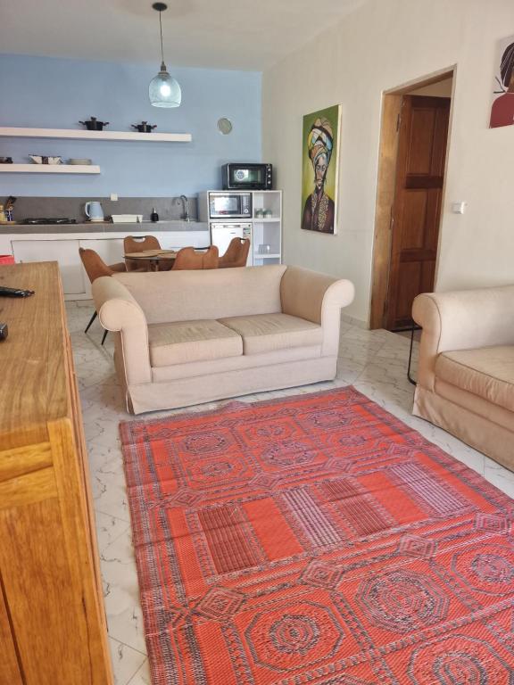 a living room with a couch and a rug at appartement cosy in Somone