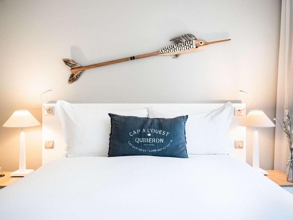 a bedroom with a bed with a bird on the wall at Sofitel Quiberon Thalassa sea & spa in Quiberon