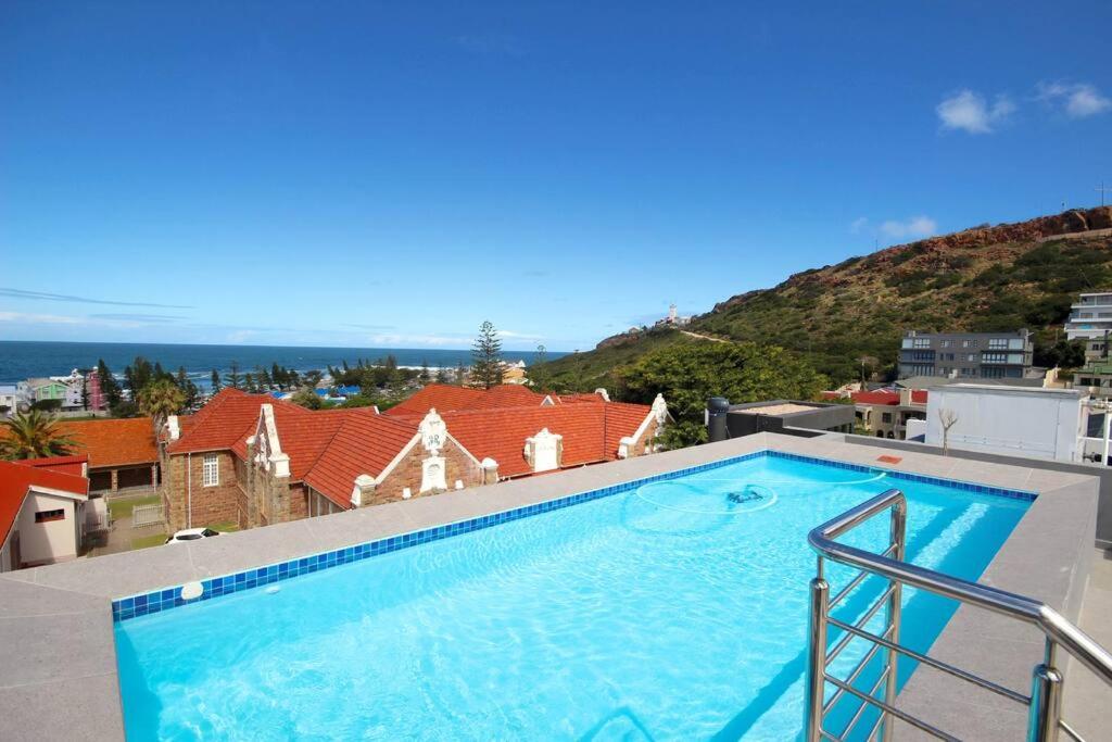 a large swimming pool on the roof of a house at 302 Mossel Cove Sea View Deluxe in Mossel Bay