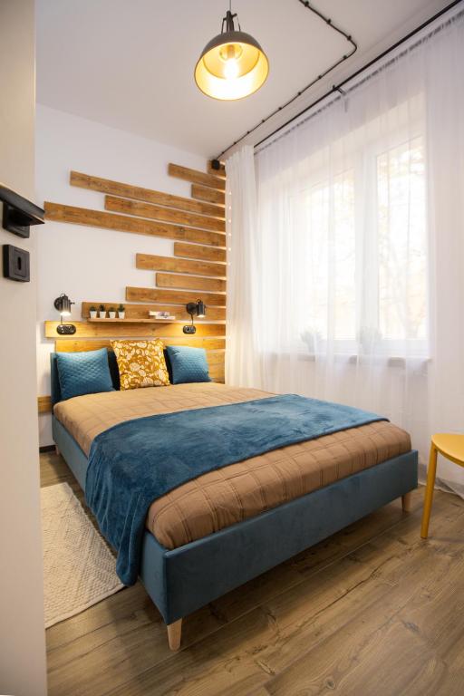 a bedroom with a large bed with a blue blanket at Apartament Blues, ul Jastrzębia in Lublin