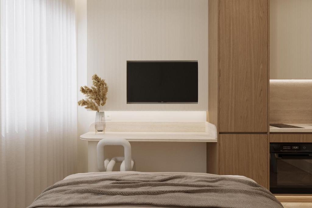 a bedroom with a television on a shelf with a chair at Luxury Living-Suite 1 in Athens