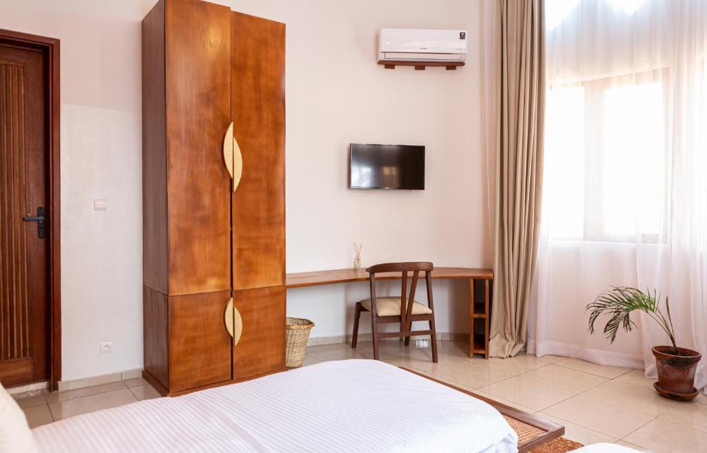 Postel nebo postele na pokoji v ubytování Tamarin Hôtel Cotonou