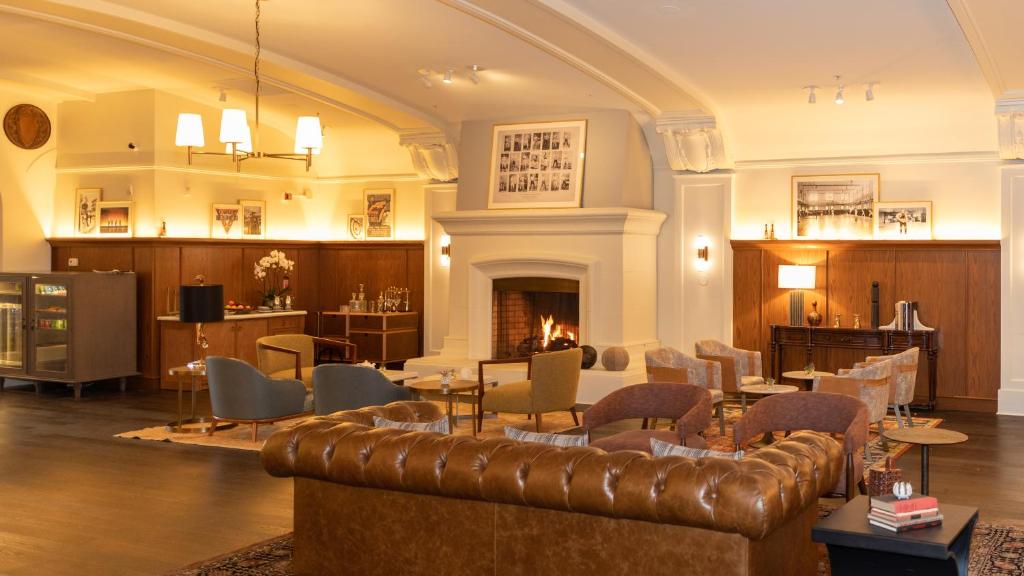 a lobby with a couch and chairs and a fireplace at Harbor Court Hotel in San Francisco