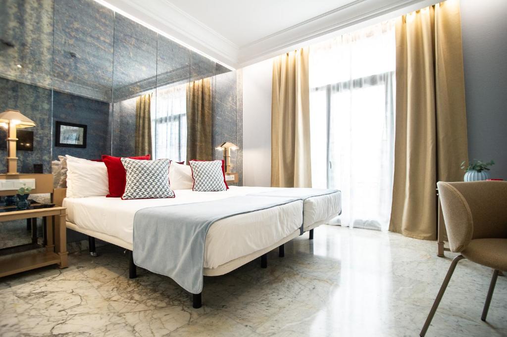 Posteľ alebo postele v izbe v ubytovaní AZZ Mérida Medea Hotel
