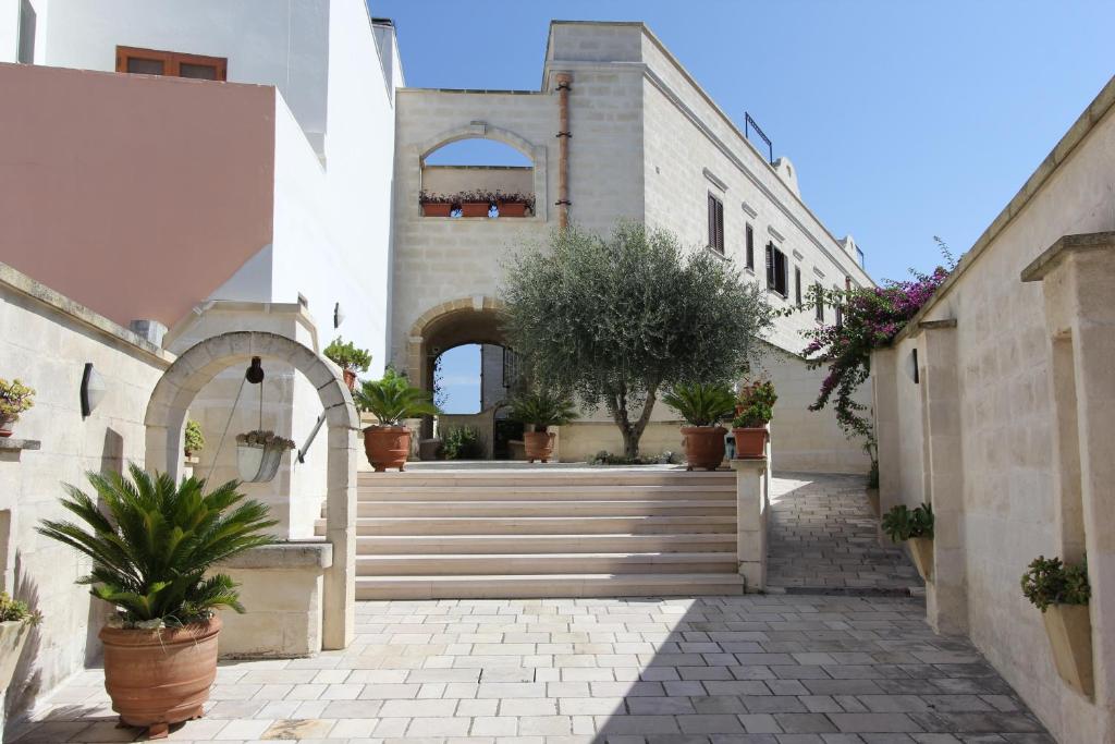 a building with stairs and potted plants in a courtyard at Borgo Antico in Diso