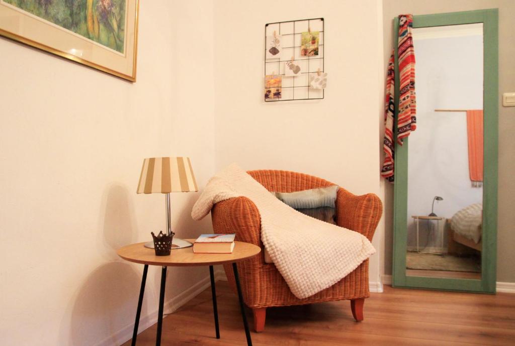 a room with a wicker chair and a table at Villa Kolck in Xanten