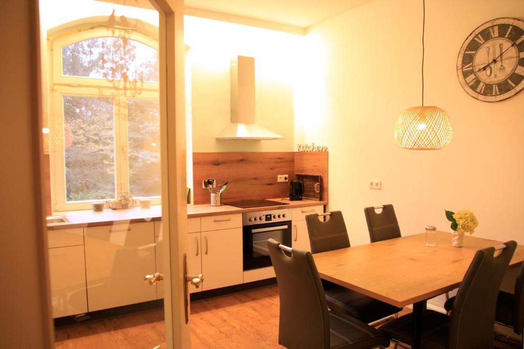 a kitchen with a wooden table and a dining room at Villa Kolck in Xanten