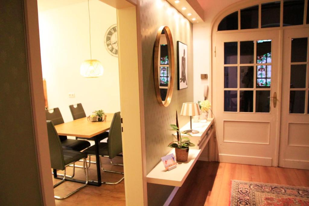 a dining room and kitchen with a table and a door at Villa Kolck in Xanten