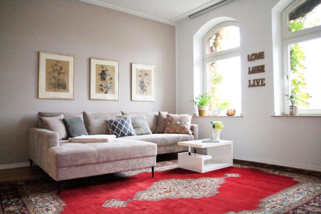 a living room with a couch and a red rug at Villa Kolck in Xanten