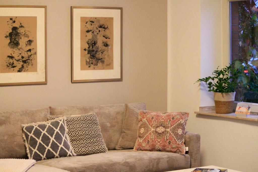a living room with a couch with pillows on it at Villa Kolck in Xanten