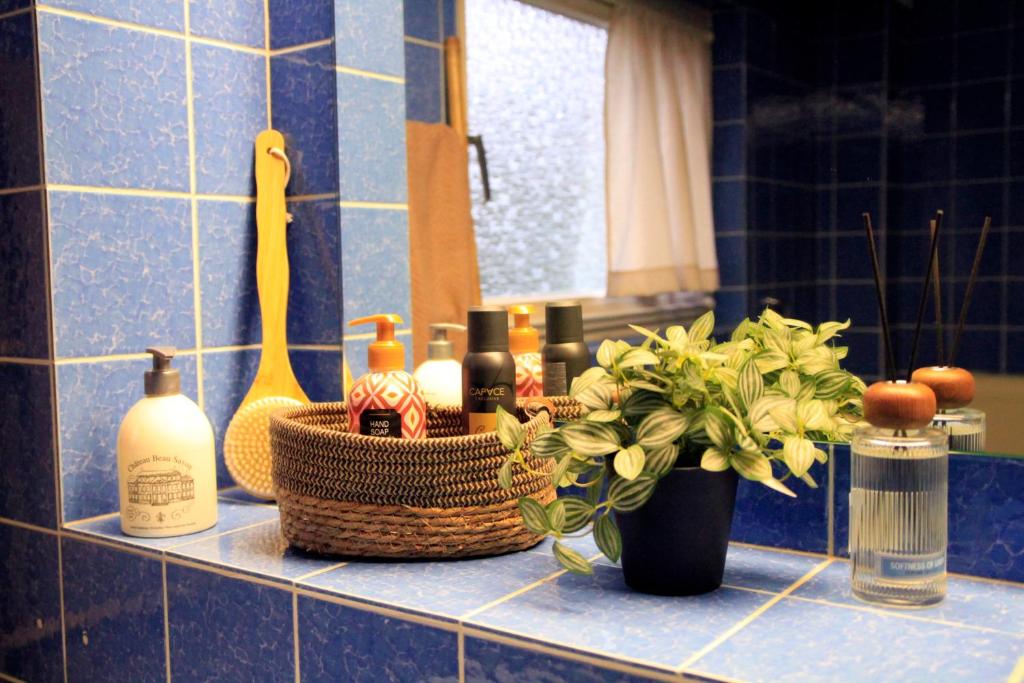 a bathroom counter with bottles of soap and flowers at Villa Kolck in Xanten