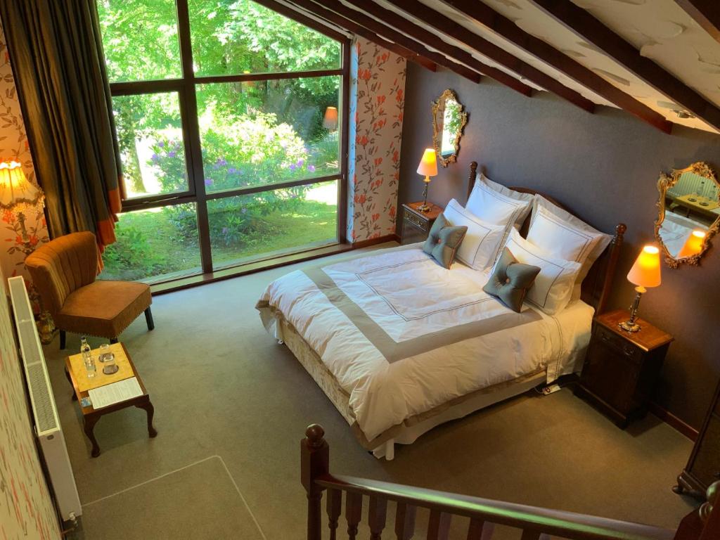 a bedroom with a bed and a large window at Havenwood in Ayr