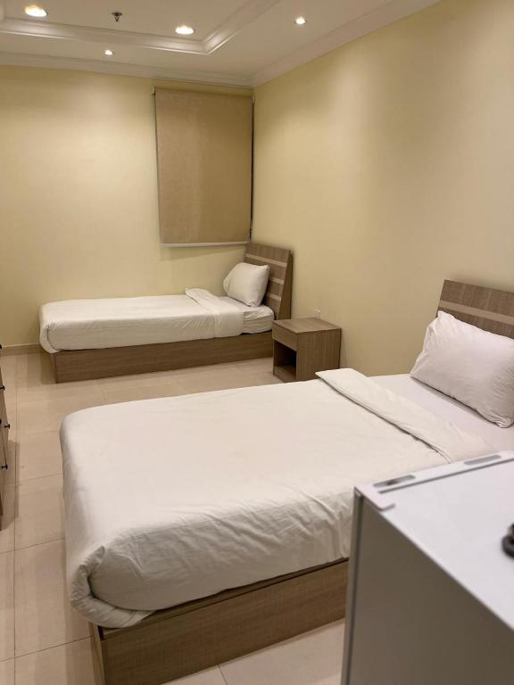 Postel nebo postele na pokoji v ubytování Al tawfeeg hotel - Al Azizyah