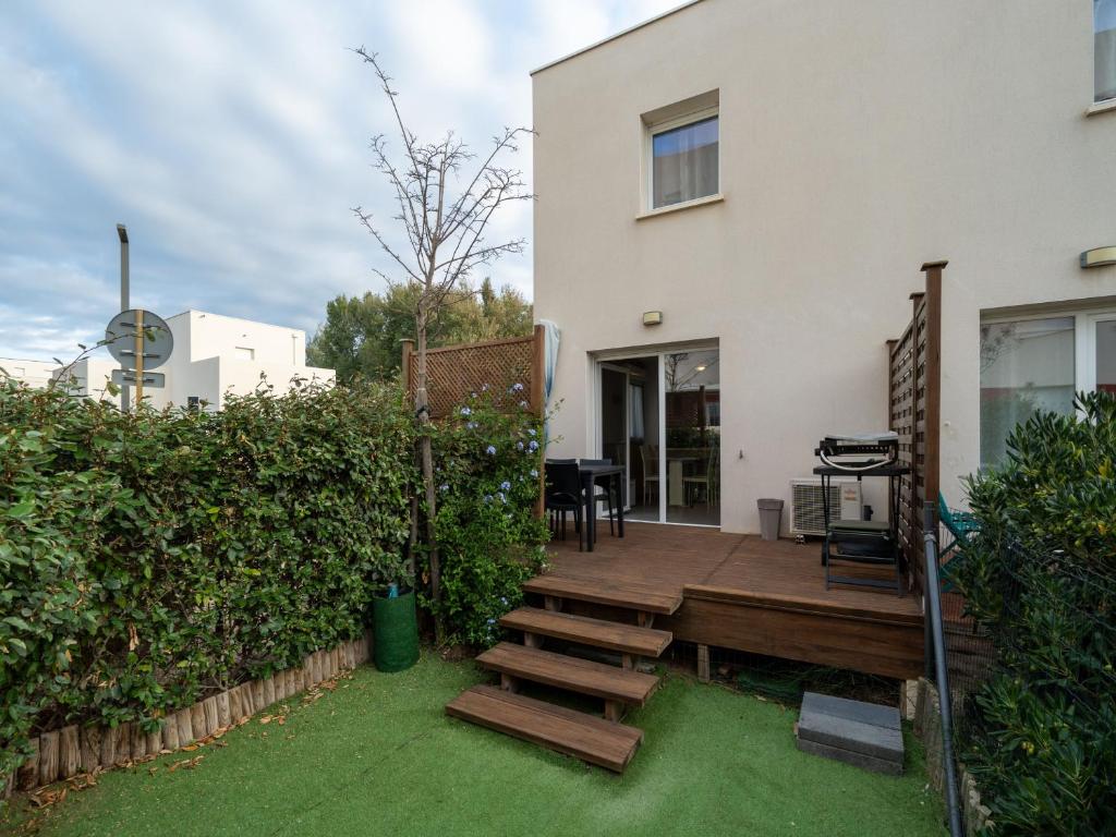 une terrasse en bois devant une maison dans l'établissement La DUNE N 01 - VILLA 3P6, à Valras-Plage
