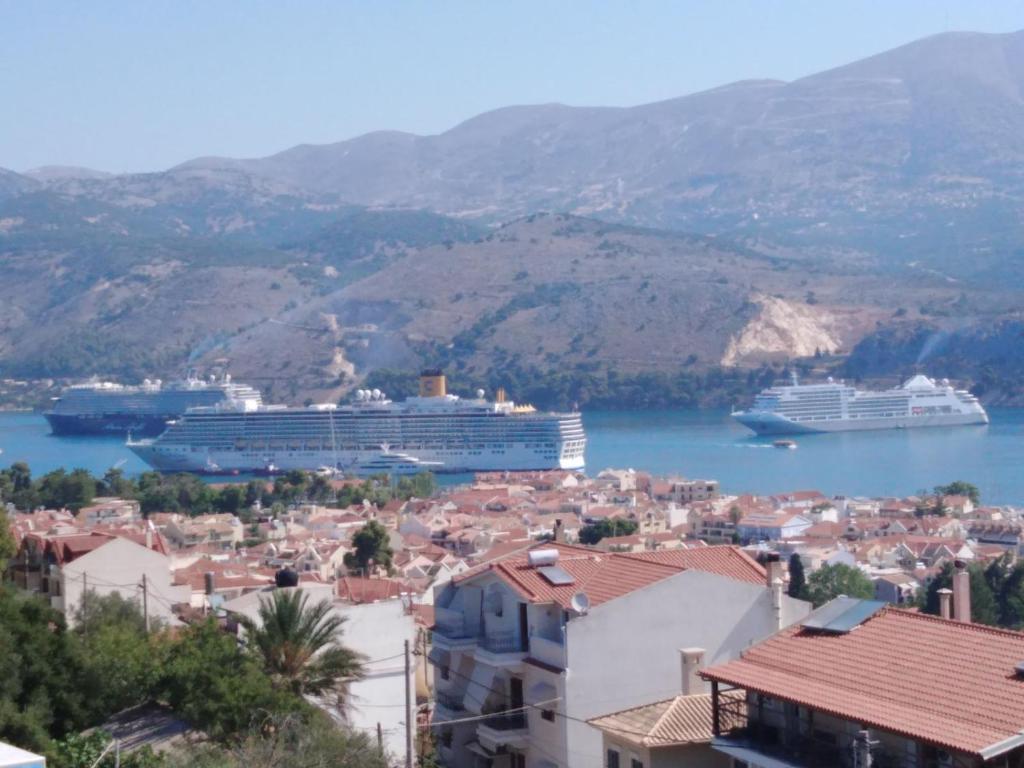 two cruise ships docked in the water near a city at ELENA SEAVIEW house in Argostoli