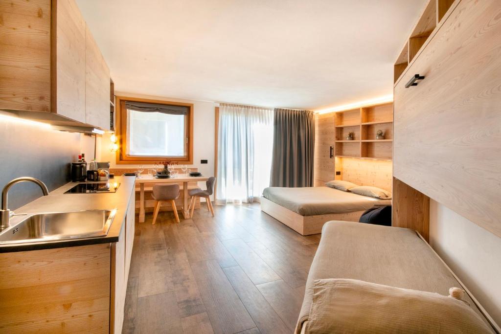 a room with a kitchen and a living room at BORMIO N'JOY in Bormio
