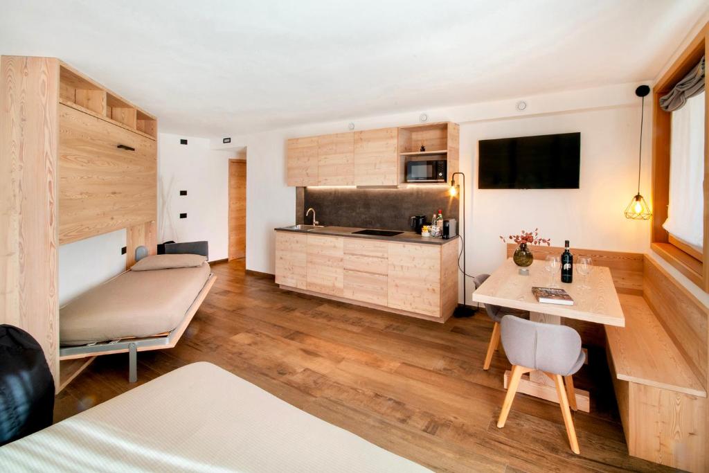 a room with a kitchen and a living room at BORMIO N'JOY in Bormio
