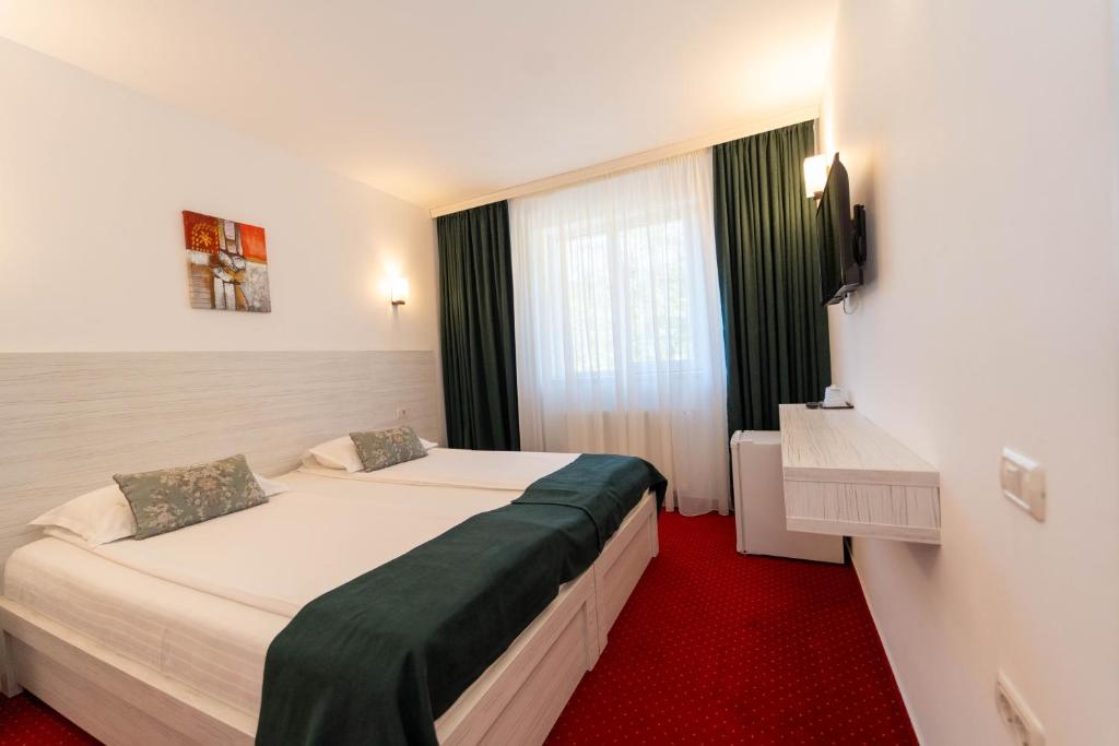 Postel nebo postele na pokoji v ubytování Hotel Cirus