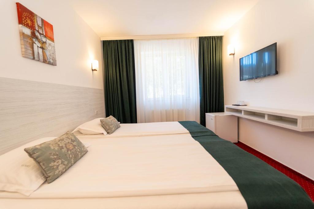 Postel nebo postele na pokoji v ubytování Hotel Cirus